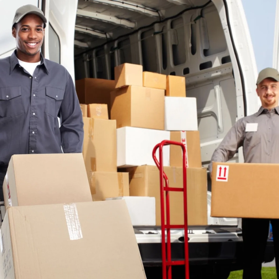 Delivery workers unloading boxes from truck.