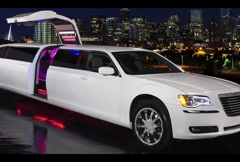 White limousine with open gullwing door.