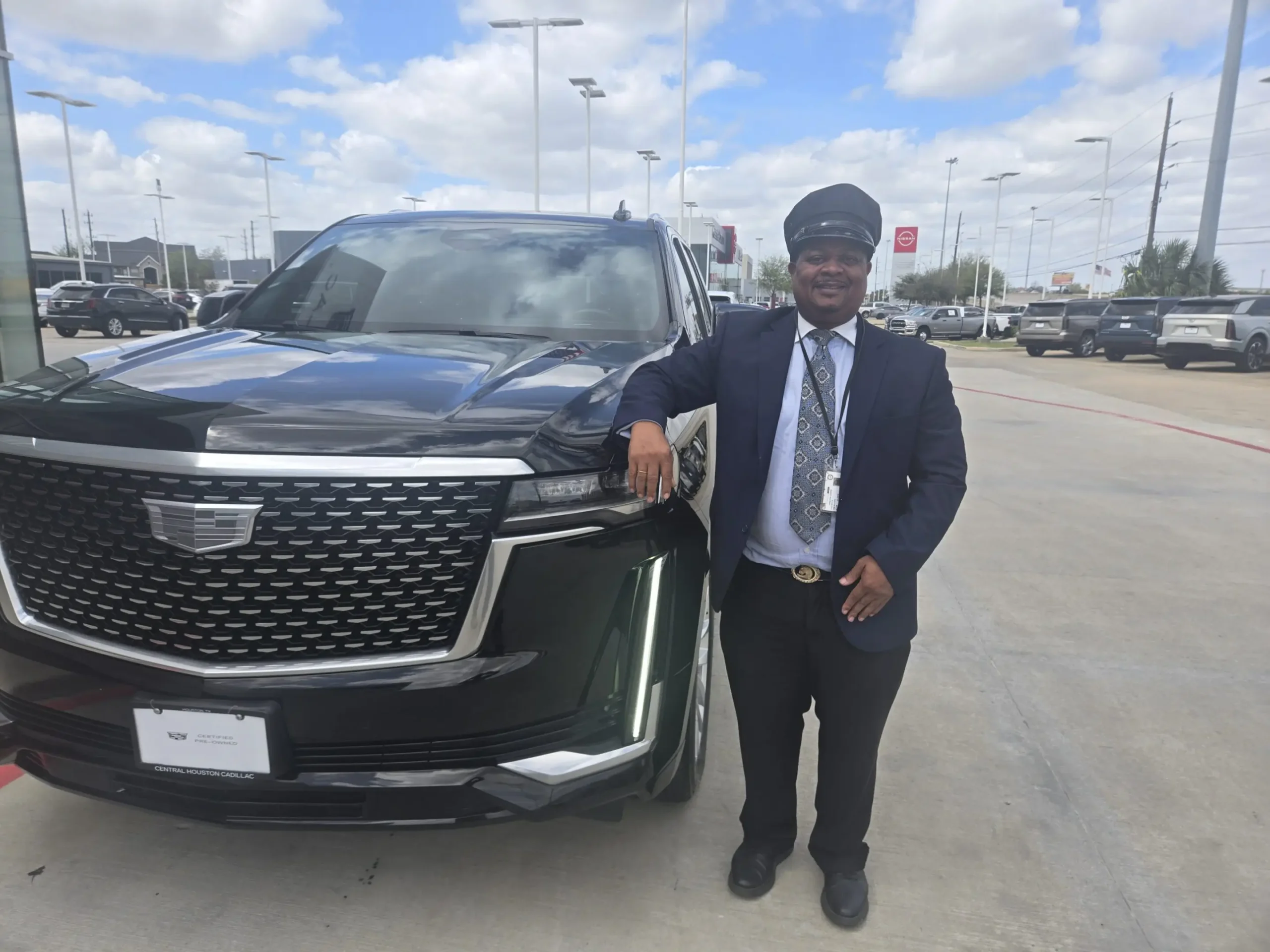 Man standing beside a large black SUV.
